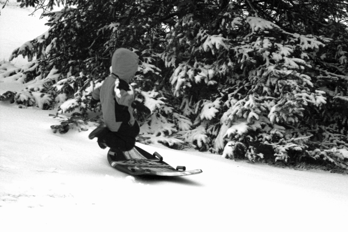 Picture of a boy jumping onto a snow slider.